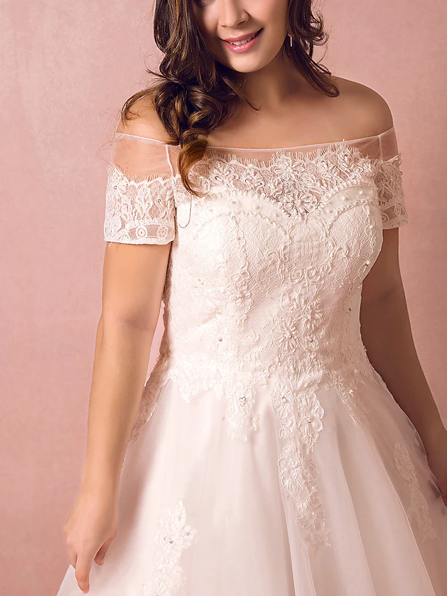 Full view of an A-line wedding dress with a flowing tulle skirt.