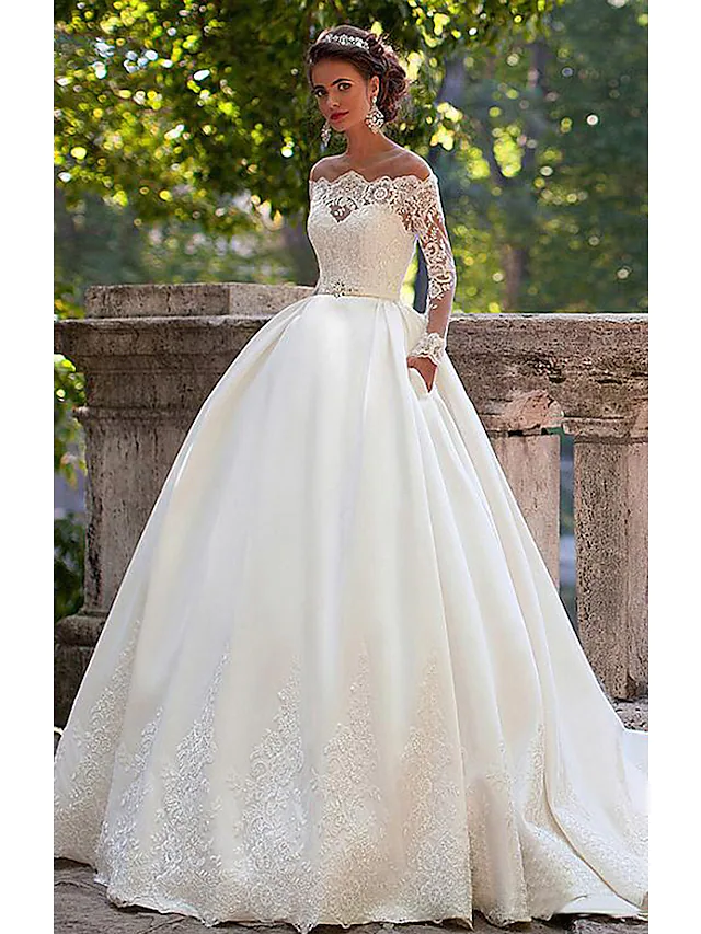 Elegant A-Line wedding dress with off-shoulder neckline and long lace illusion sleeves.