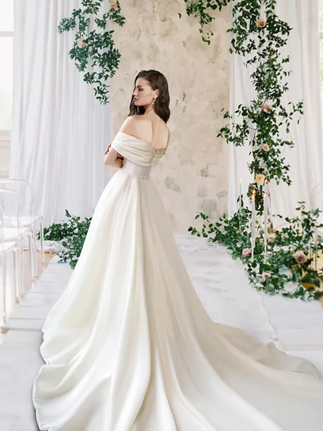 Full view of A-Line wedding gown featuring a court train and split front.