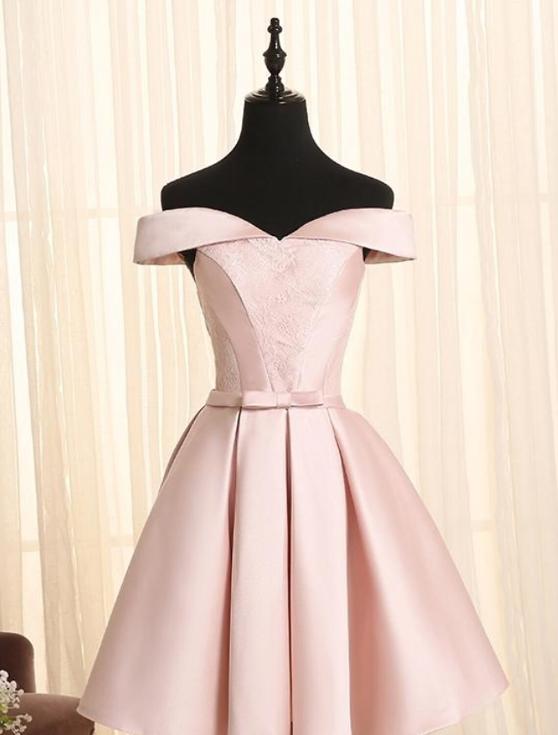 Elegant A-line off-shoulder satin cocktail dress with bows and lace detail.