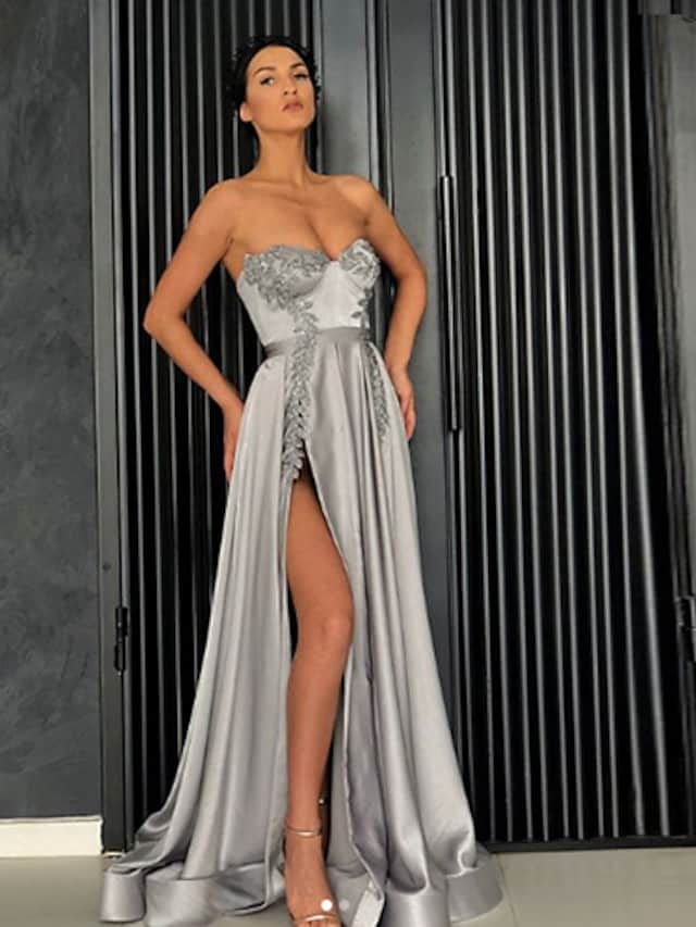 Close-up of the off-shoulder neckline and satin fabric of the formal dress.