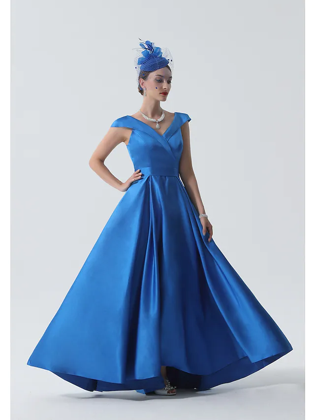 Side view of the satin A-line dress with pleats and asymmetrical detail.