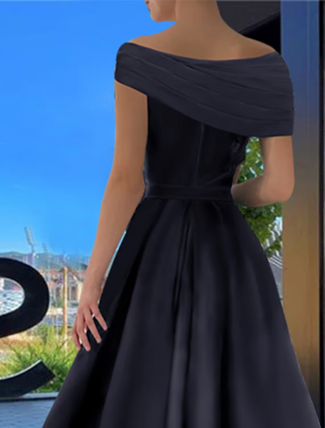Back view of the elegant A-Line off-shoulder black satin prom dress.