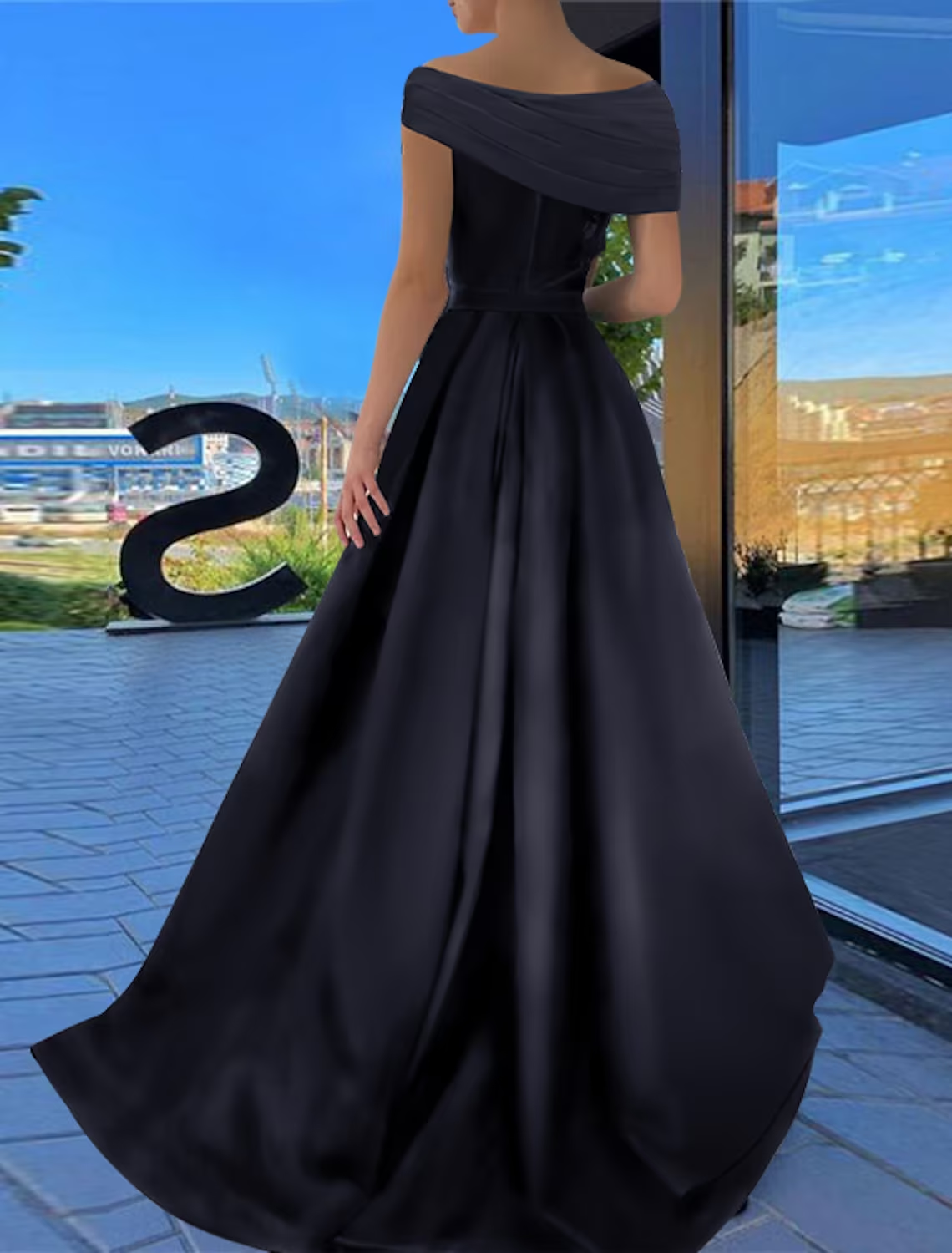 Close-up of the satin fabric and ruched detail on the black prom dress.