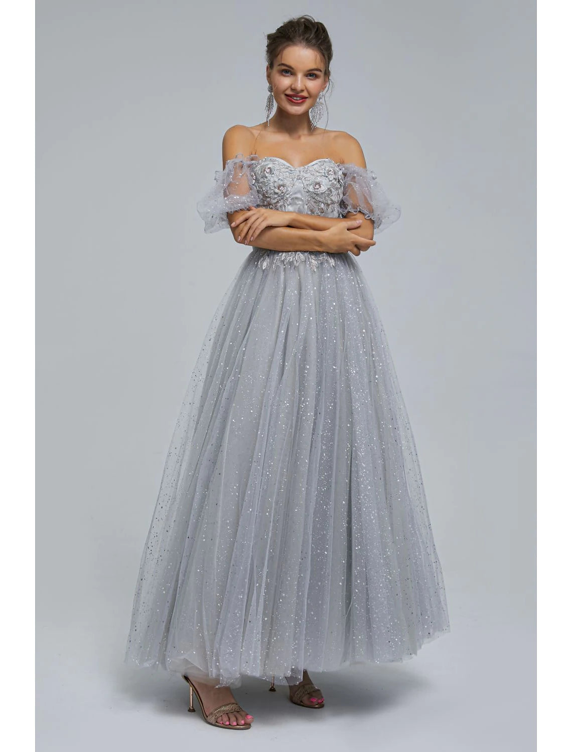 Back view of the A-line off-shoulder tea length dress with tulle skirt.