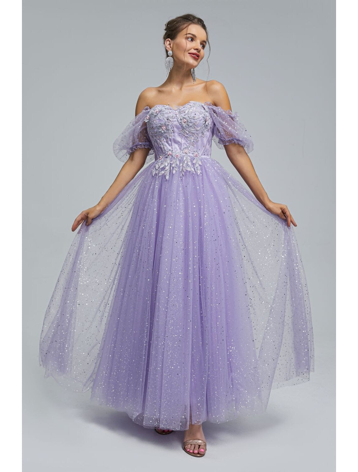 Model posing in the elegant off-shoulder prom dress.