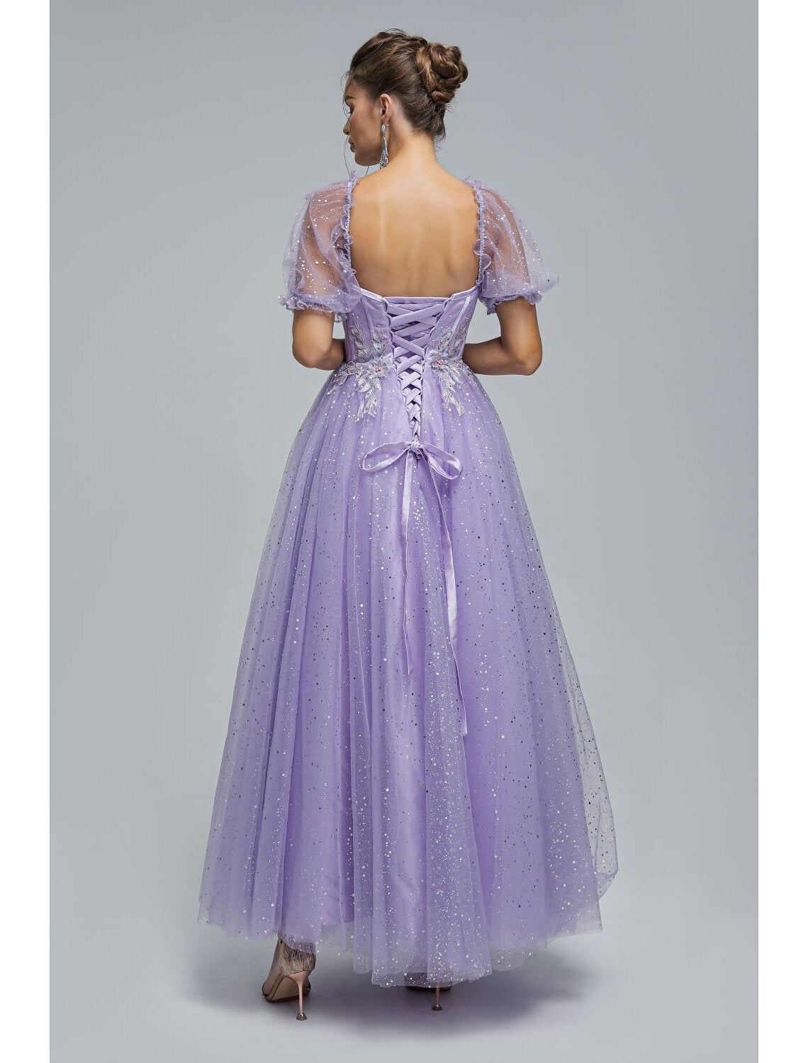 Detail of the off-shoulder neckline and short sleeve on the dress.