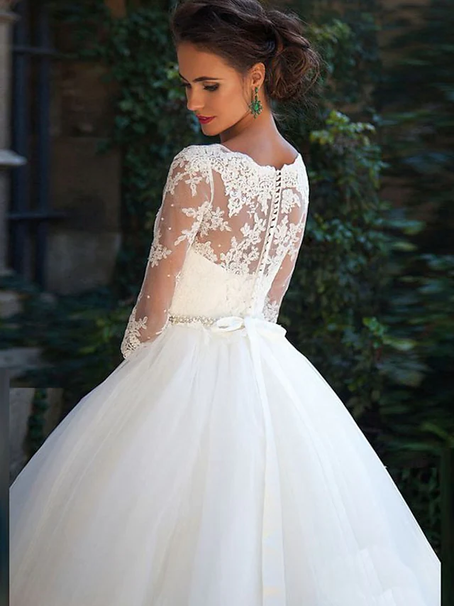 Bride wearing a romantic A-Line off-shoulder wedding gown.
