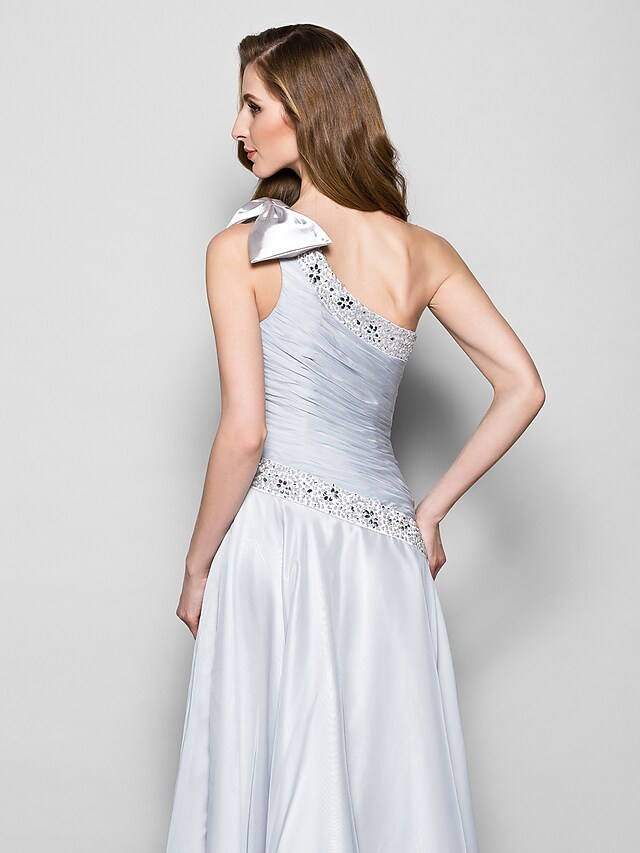 Side view of the flowing floor-length chiffon gown.