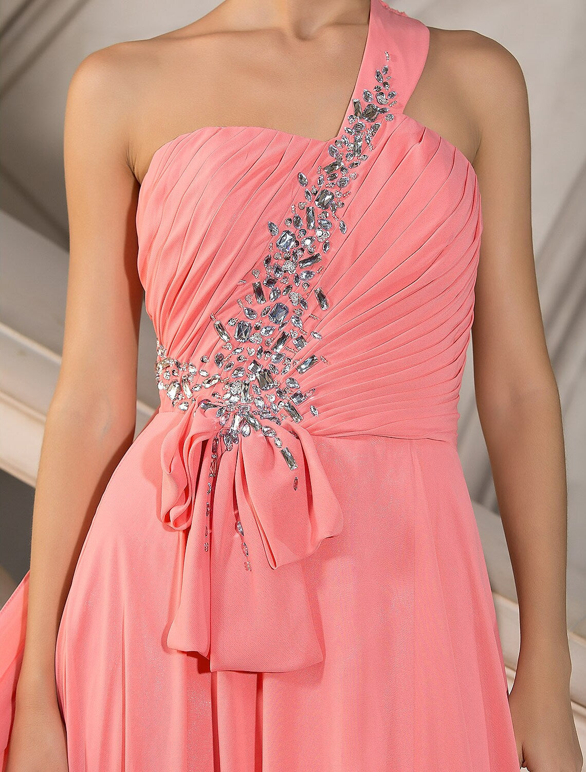 Side profile of the elegant one-shoulder chiffon gown.