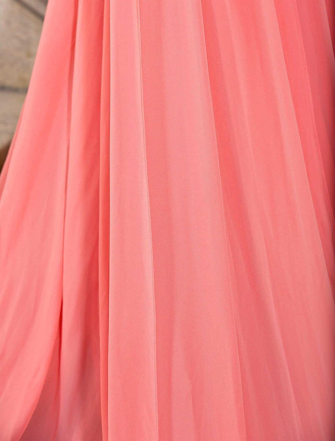 Detailed view of the chiffon fabric and draping on the elegant gown.
