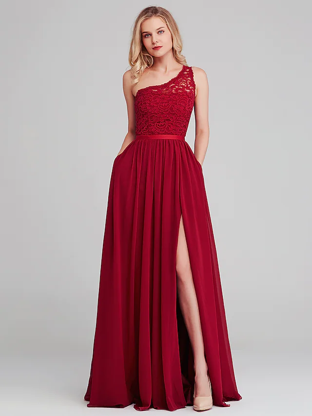 Close-up of the one-shoulder neckline and lace detail on the dress.