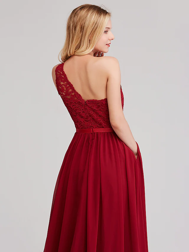 Detail of the sash and flowing chiffon skirt of the bridesmaid dress.