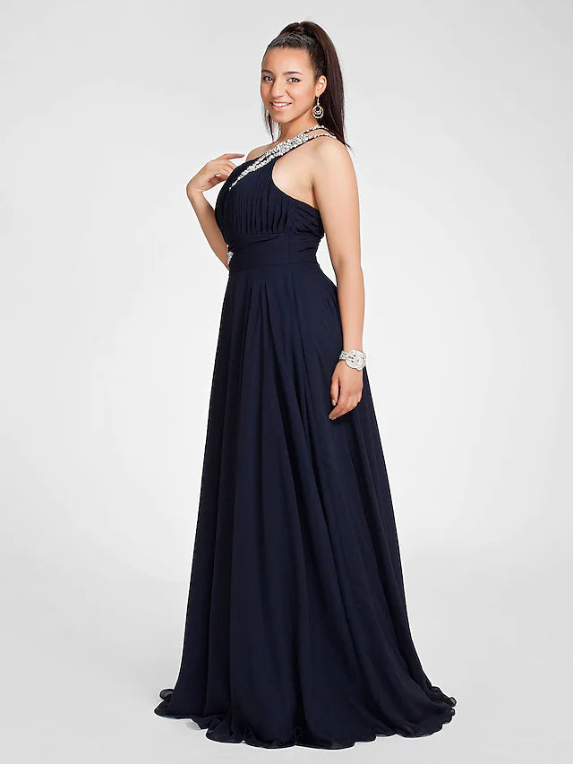 Woman posing in the elegant one shoulder chiffon dress with a sweep train.