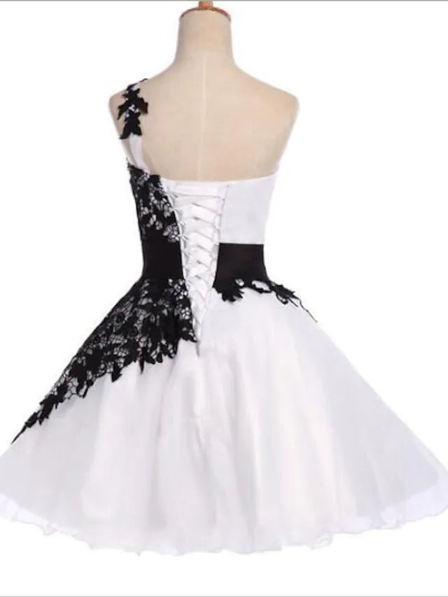 White A-line one-shoulder cocktail dress with color block and appliques.