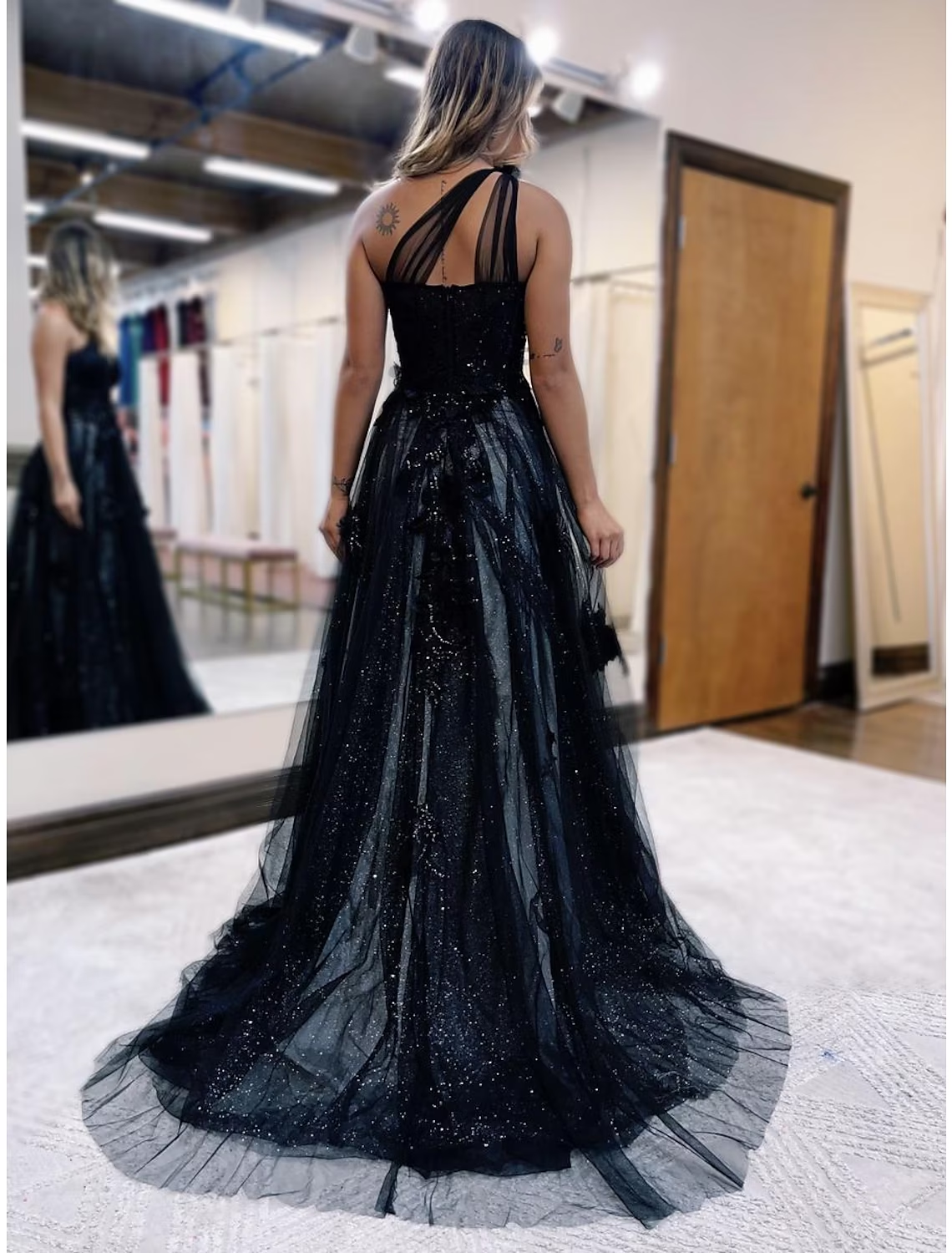 Back view of the A-Line color block prom dress showcasing the sweeping train and backless design.