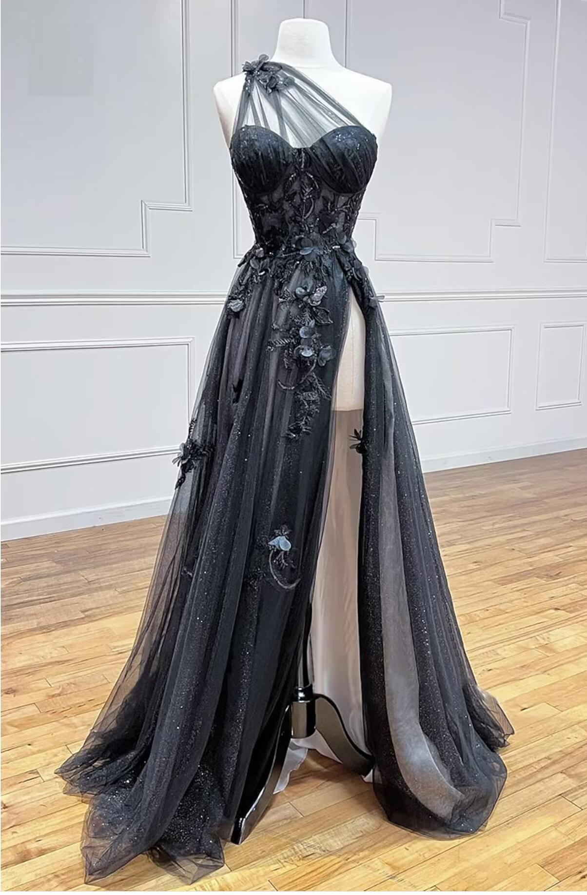 Model wearing an elegant one-shoulder tulle prom dress with pleats and appliques.