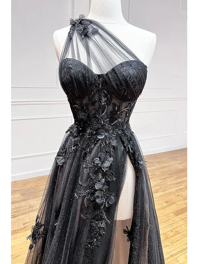 Side view of a model in a floor-length one-shoulder prom gown, highlighting the tulle skirt.