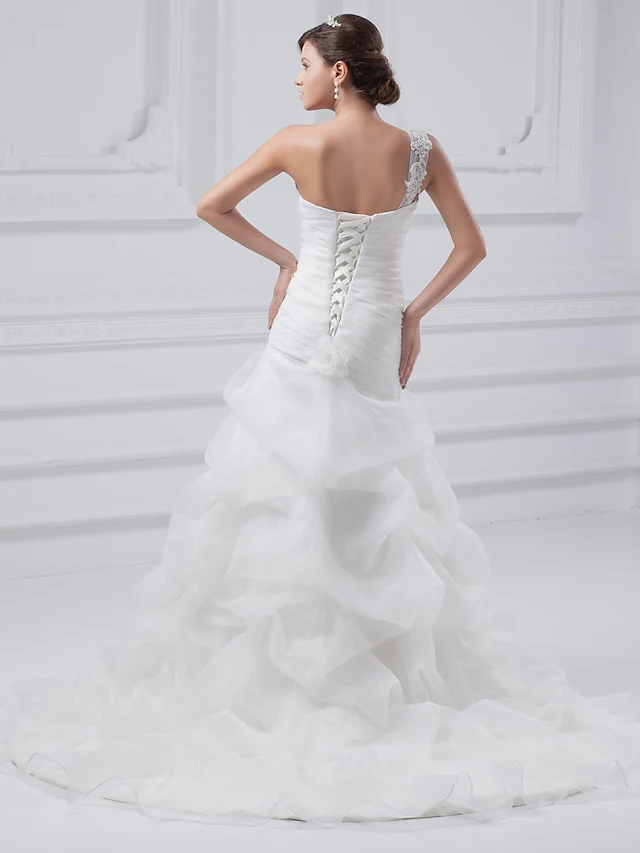 Side profile of A-Line wedding gown with one shoulder and pick-up skirt detail.