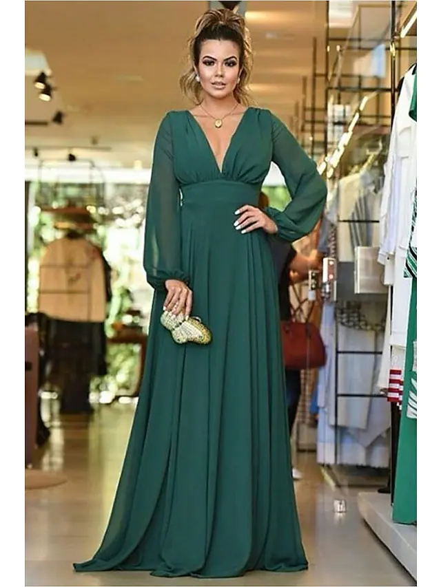 Woman wearing an elegant A-line chiffon bridesmaid dress with a plunging neckline and pleats, front view.