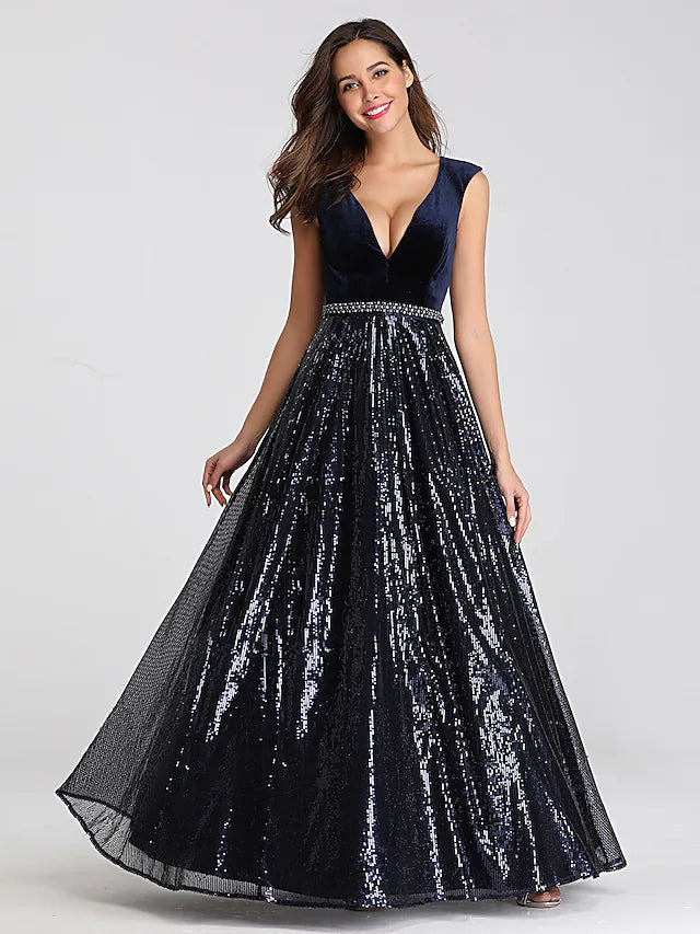 Model wearing a sequined A-line prom dress with a plunging neckline and sash.