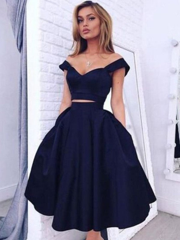 Model wearing an elegant A-line off-shoulder two-piece satin tea-length homecoming dress.