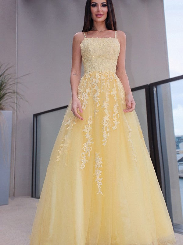 Elegant A-line prom dress with spaghetti straps and applique details.
