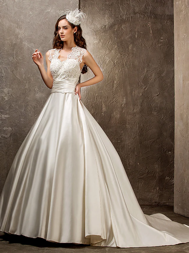 Back view of an A-Line wedding dress showing lace detailing and train.