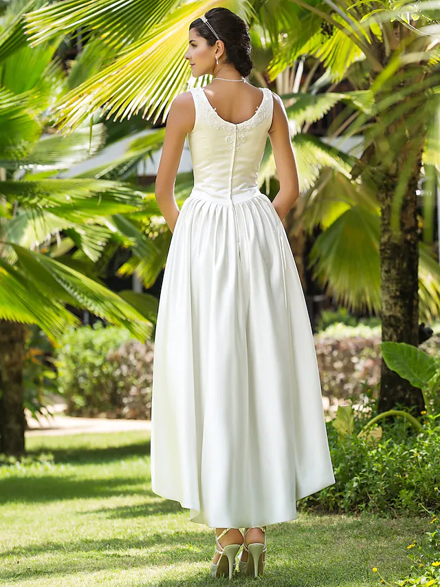 Bride posing in the Princess A-Line wedding dress, showing the functional pockets.