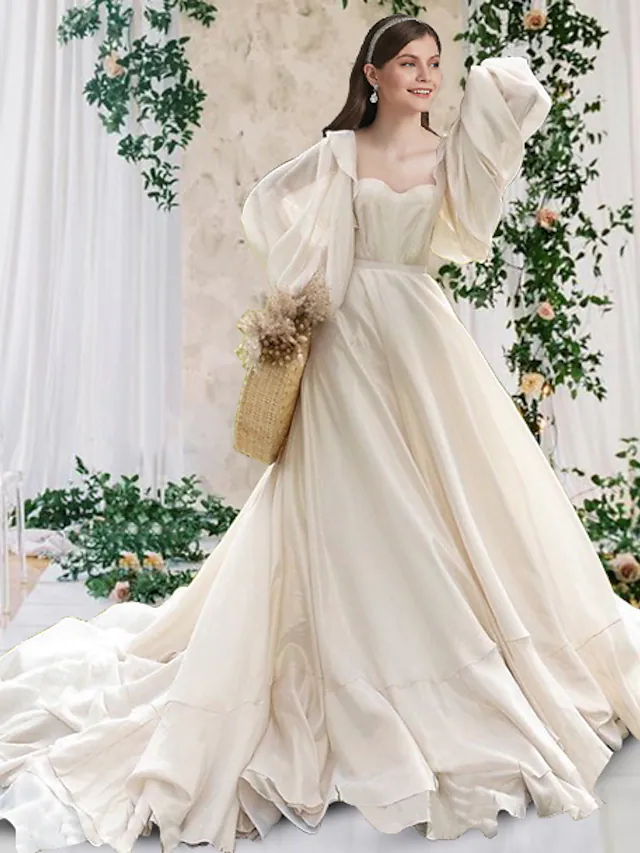 Elegant A-Line chiffon wedding dress with scoop neck, long sleeves, and chapel train.