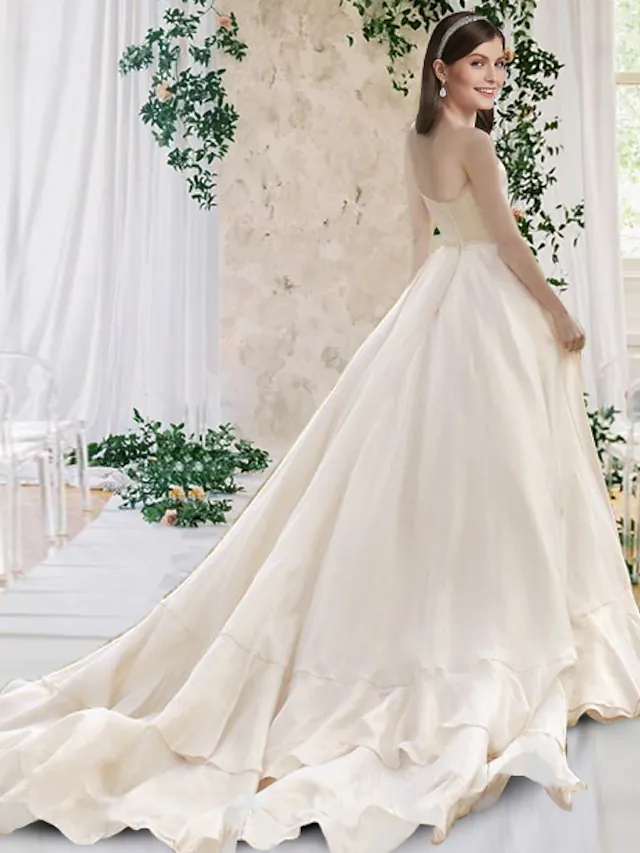 Back view of the A-Line wedding dress, highlighting the chapel train and pleats.