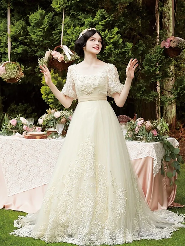 Elegant A-line wedding dress with scoop neck, half sleeves, lace, and tulle details.