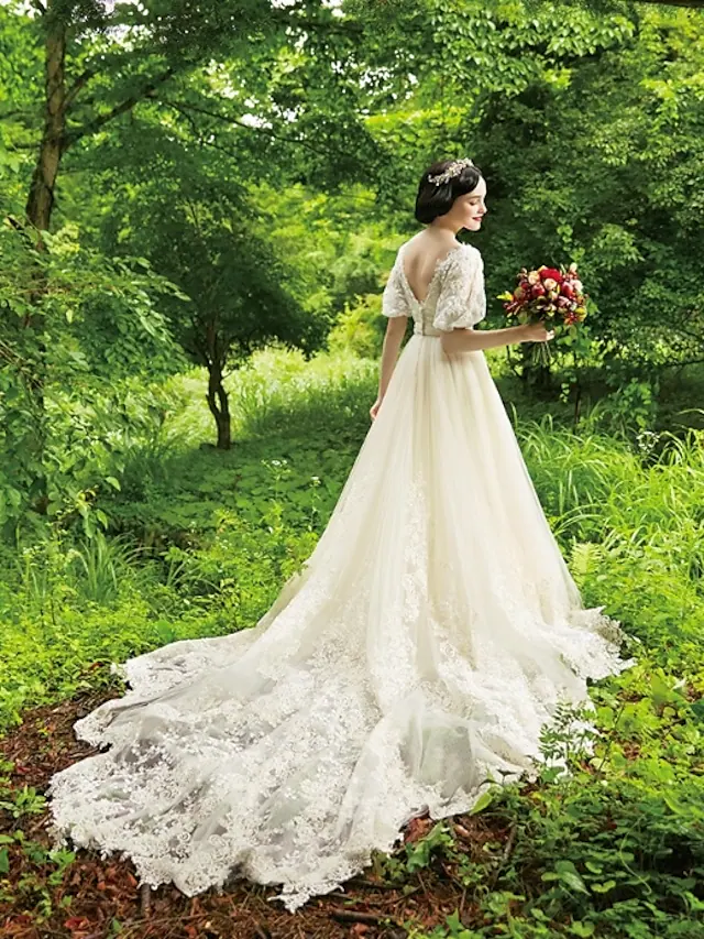 Close-up of the lace, beading, and applique details on the wedding dress bodice.