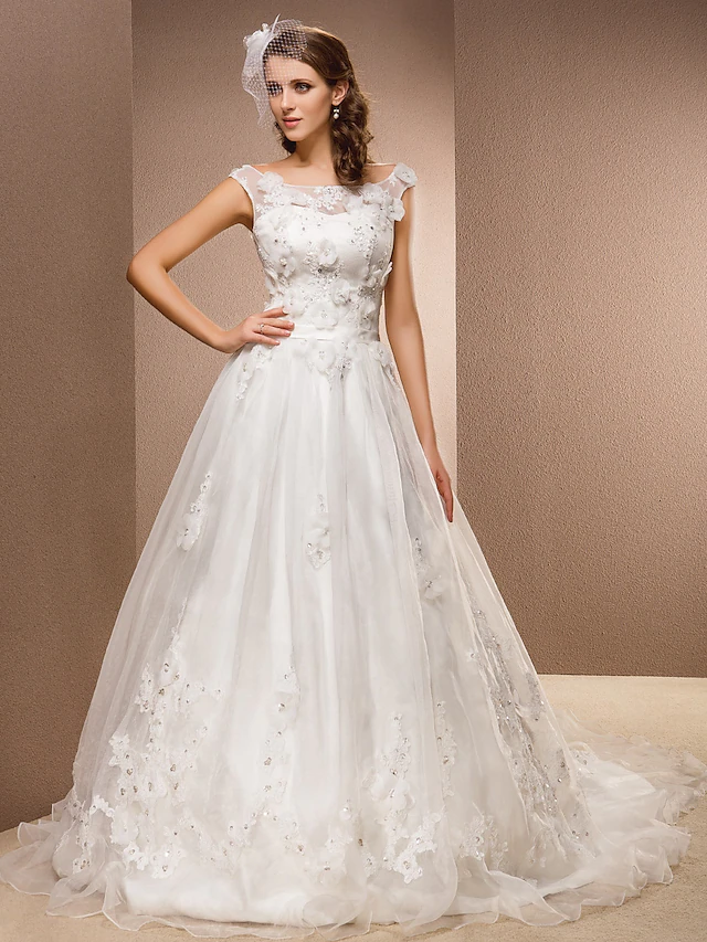 Elegant A-line wedding dress with a scoop neck and chapel train, adorned with lace and organza appliques.