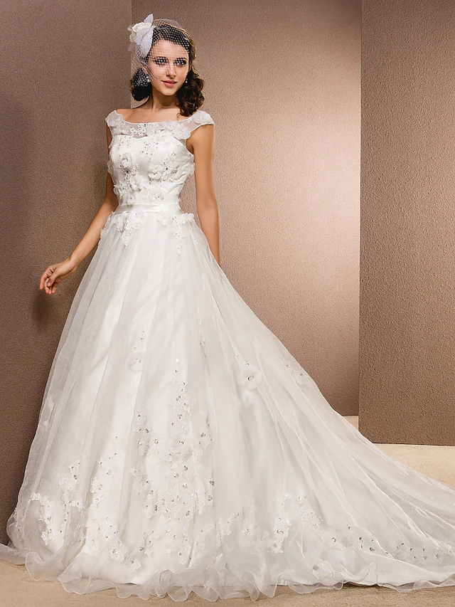Back view of the A-line wedding dress, showcasing the chapel train and delicate beading.