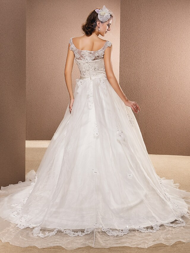 Close-up of the intricate lace and organza appliques on the A-line wedding dress.