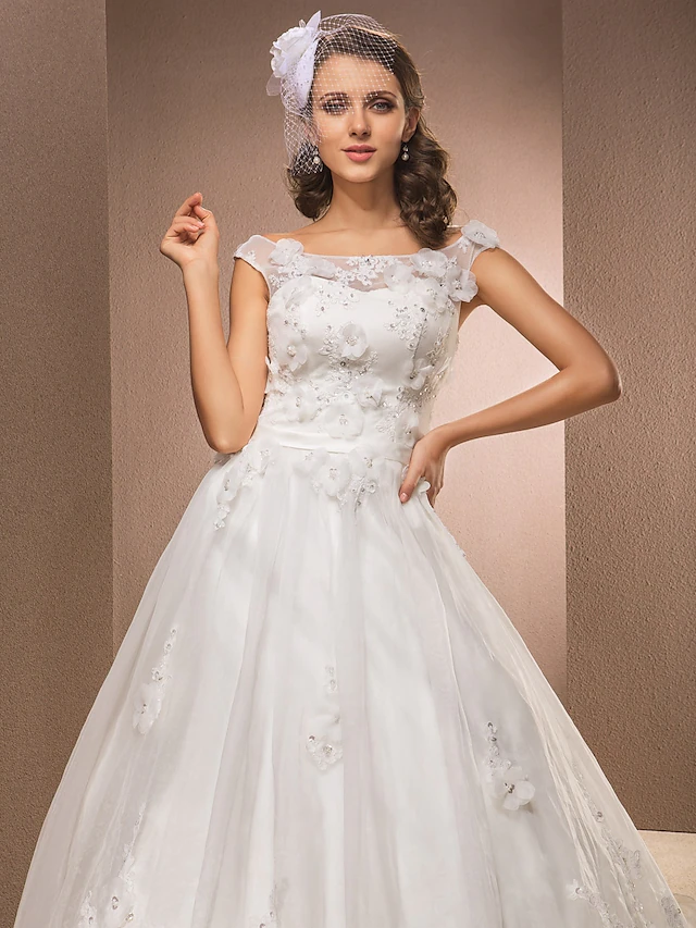 Side view of the sleeveless A-line wedding dress, highlighting the flowing chapel train.