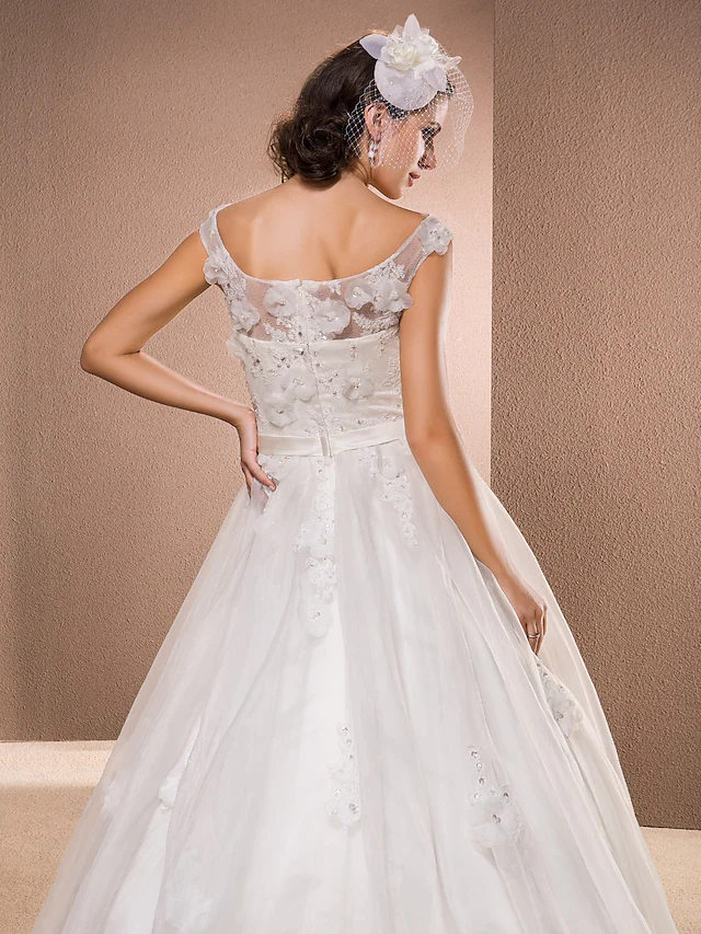 Detail of the scoop neckline and lace appliques on the bridal gown.