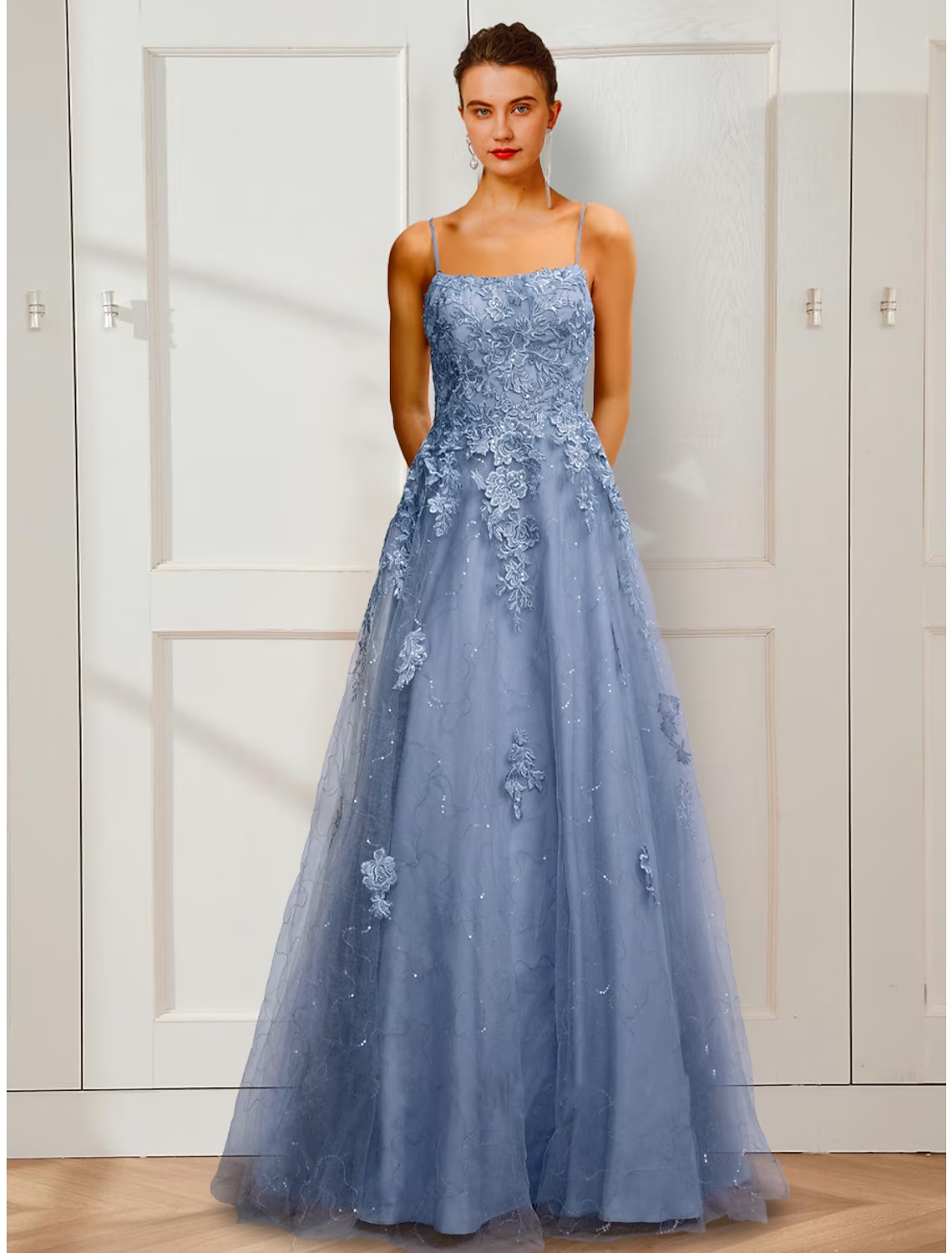 Elegant A-line prom dress with floral appliques and spaghetti straps.