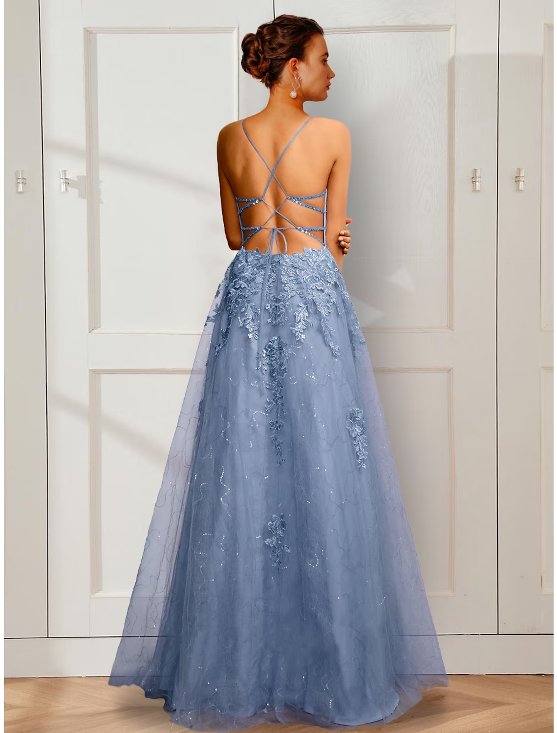 Close-up of floral appliques on satin A-line prom dress.