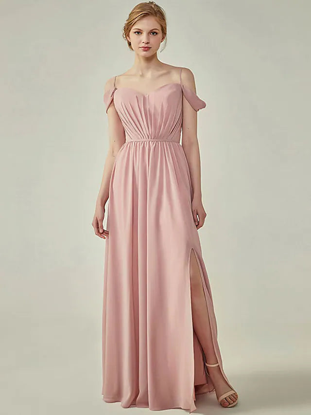 Woman wearing an elegant A-line chiffon bridesmaid dress with spaghetti straps and ruched bodice.
