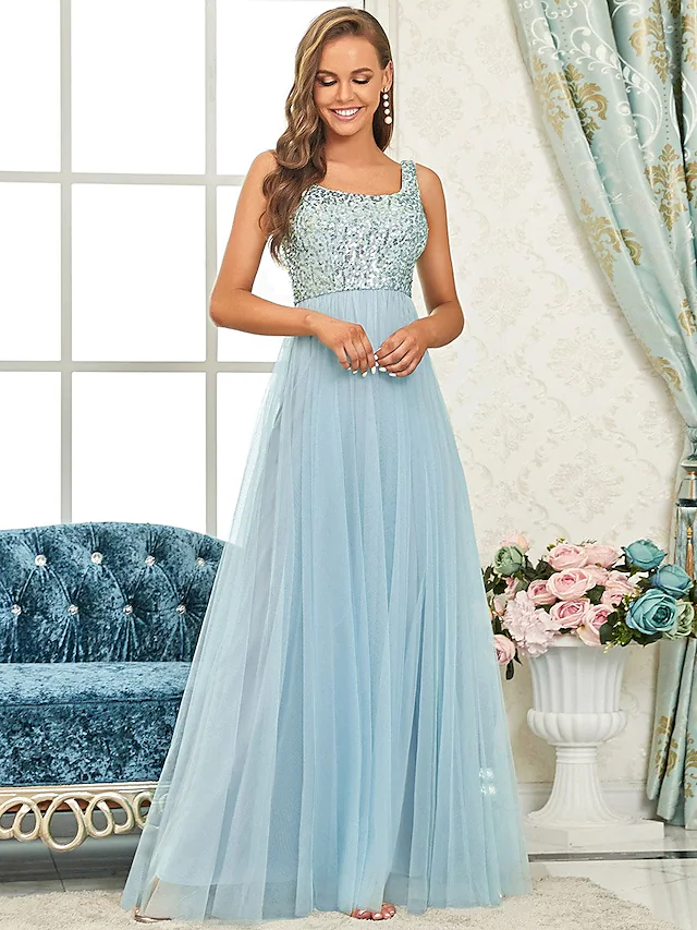 Full view of an A-line spaghetti strap sequined tulle bridesmaid dress.
