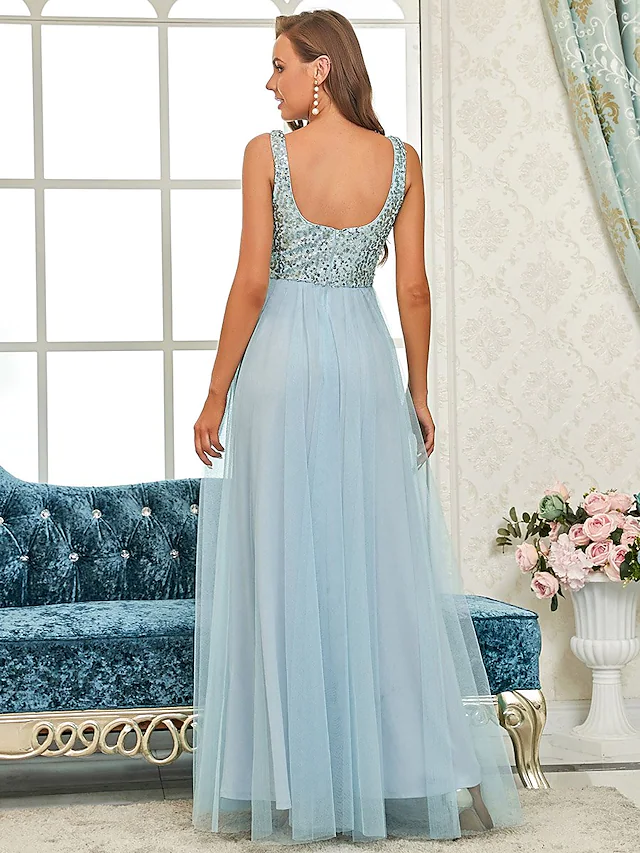 Close-up of sequin embellishments and delicate spaghetti strap on a tulle dress.