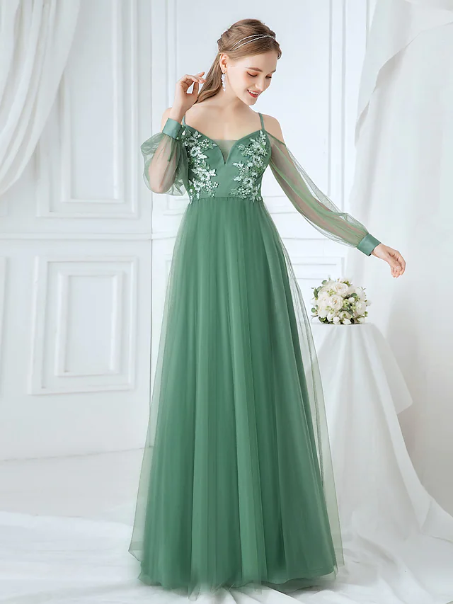 Full view of an elegant A-line tulle bridesmaid dress with appliques and spaghetti straps.
