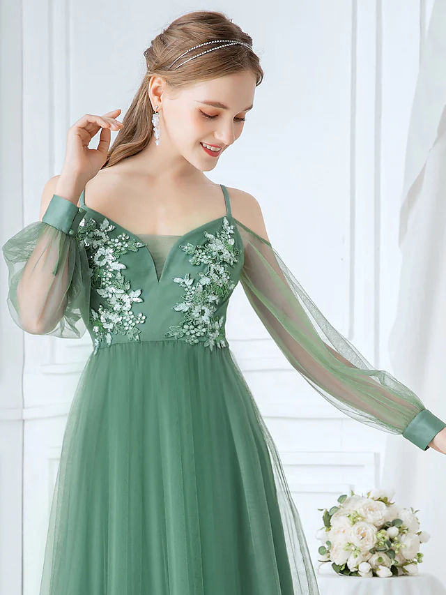 Detailed view of the delicate appliques on the soft tulle fabric of the bridesmaid dress.