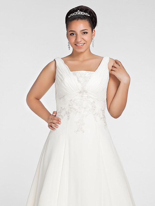 Back view of the A-line wedding dress showing chapel train and delicate draping.