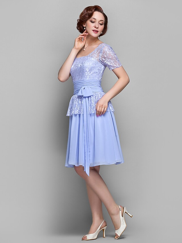 Close-up of the lace and ruched details on the dress.