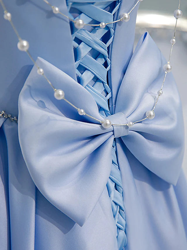 Close-up of the beading and satin fabric on the bridesmaid dress.