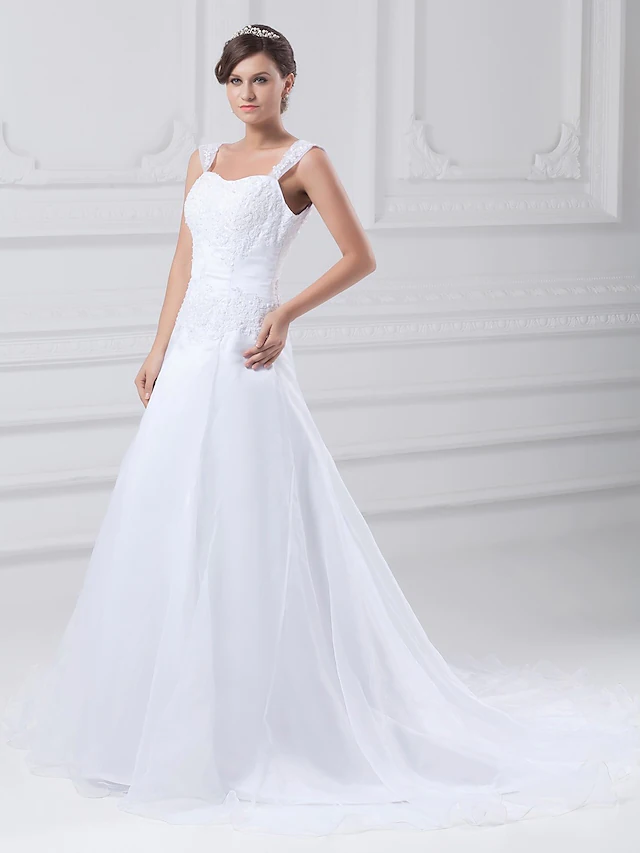 Back view of A-Line wedding dress showing chapel train and beading.
