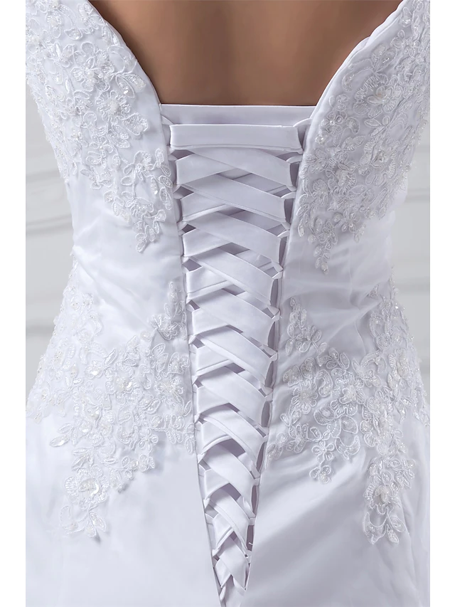 Detail of the chapel train on a satin and organza wedding dress.